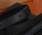 Black leather bag strap detail with stitched edge and snap button