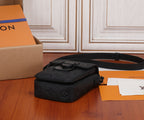 Black monogram crossbody bag with shoulder strap and compact front flap