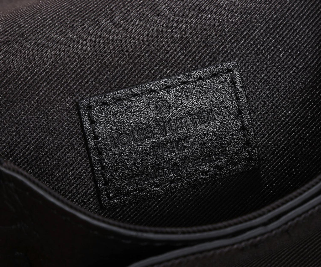 Black fabric interior label with Louis Vuitton Paris text and stitched edge