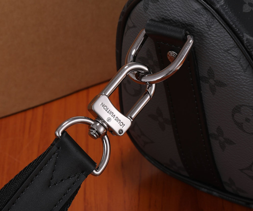 Monogram handbag hardware close-up with silver rings and black strap