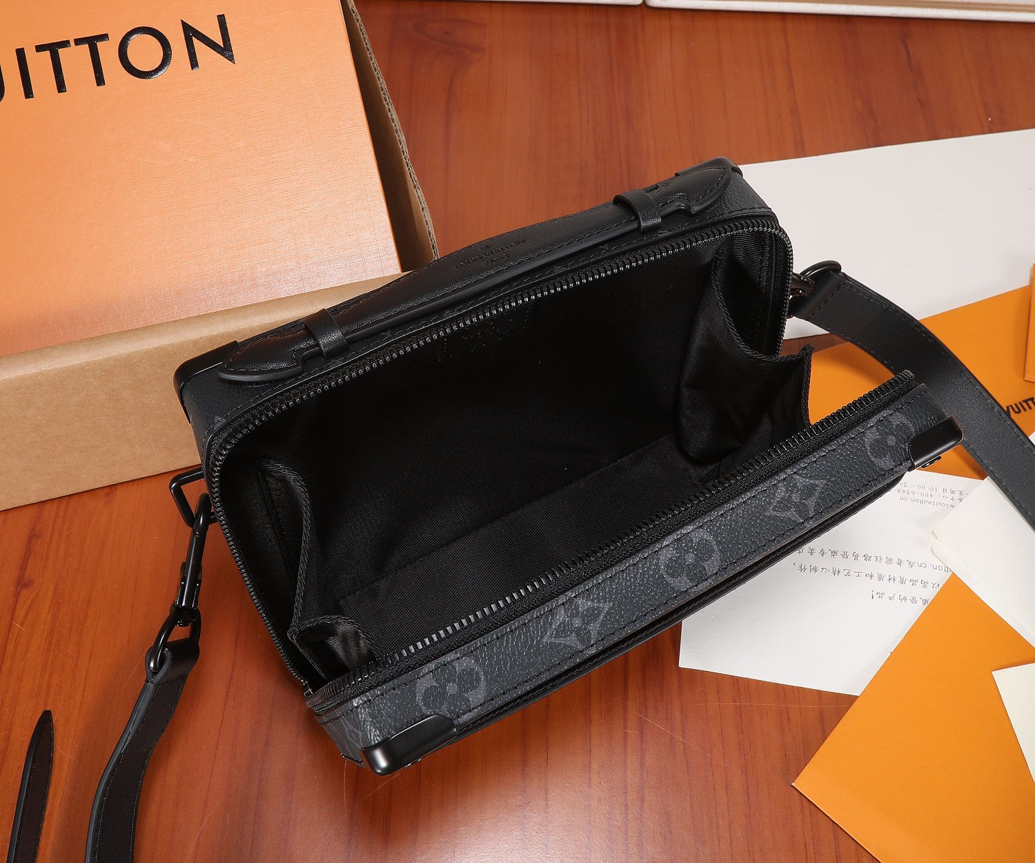 Louis Vuitton monogram bag opened to reveal dark interior lining and zipper closure.