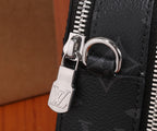 Louis Vuitton zipper pull and metal ring on dark leather bag corner