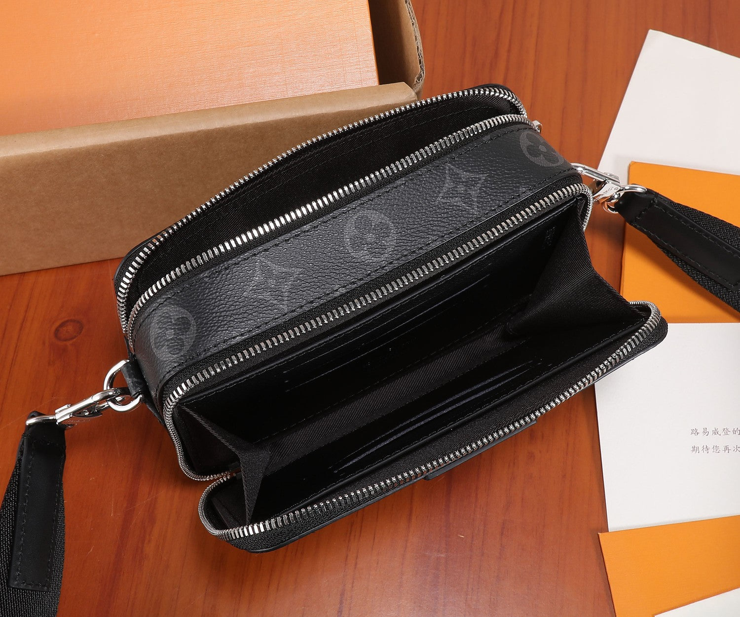 Louis Vuitton monogram crossbody bag with open top zipper and black leather interior