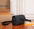 Black monogram crossbody bag with structured flap and adjustable shoulder strap