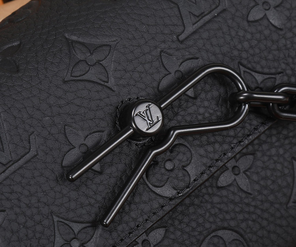 Louis Vuitton monogram bag hardware with metal clasp and black leather trim
