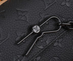 Louis Vuitton monogram bag hardware with metal clasp and black leather trim