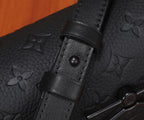 Black monogram crossbody bag strap attachment with leather tab and snap button
