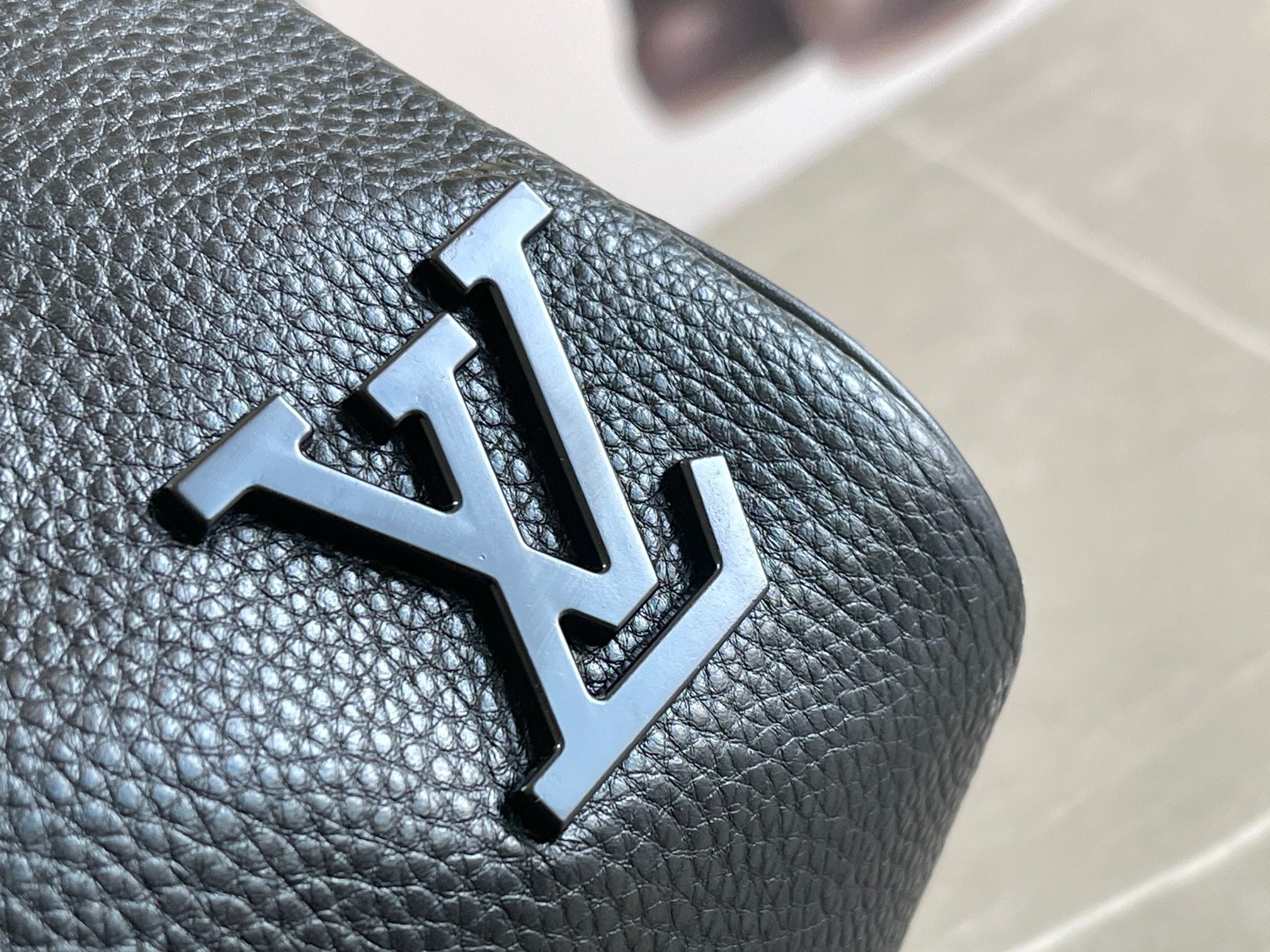 Louis Vuitton LV logo patch on dark blue textured leather duffel