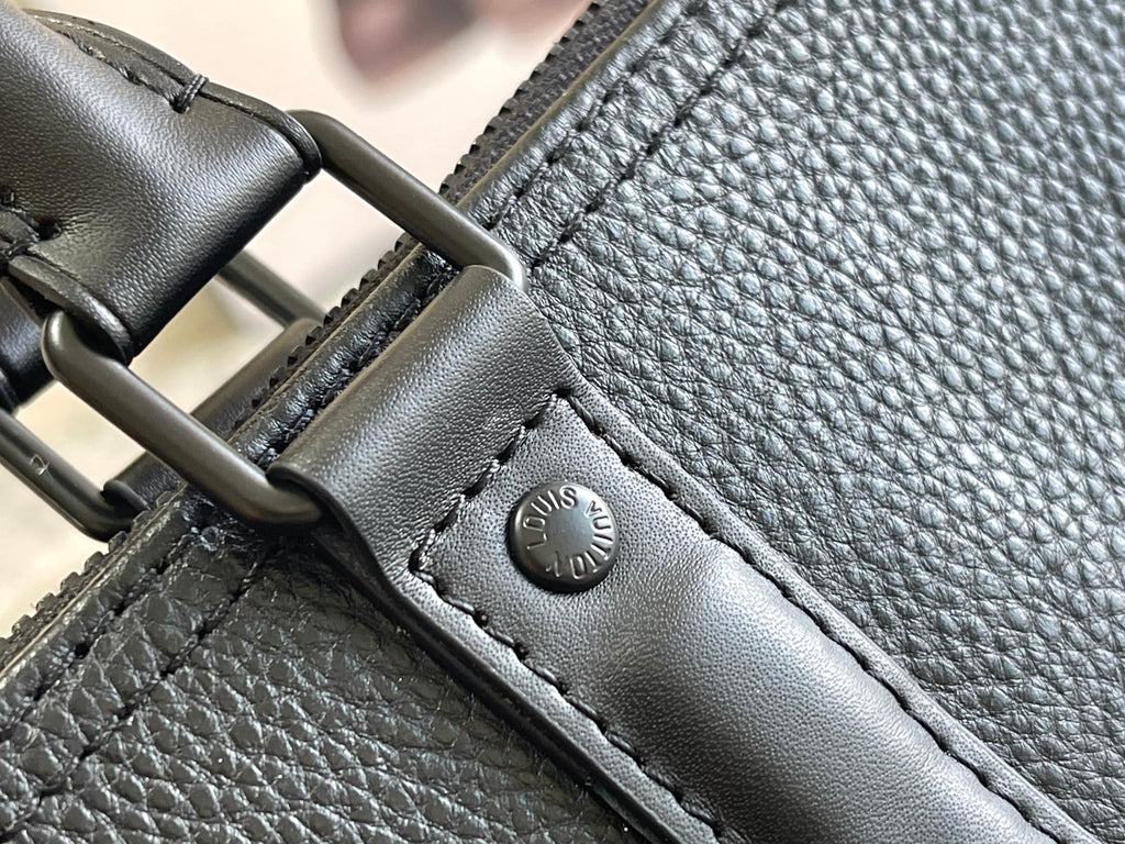 Louis Vuitton duffel bag hardware with dark blue leather strap and snap logo
