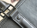 Leather bag strap attachment with metal D-ring and embossed button on dark blue leather