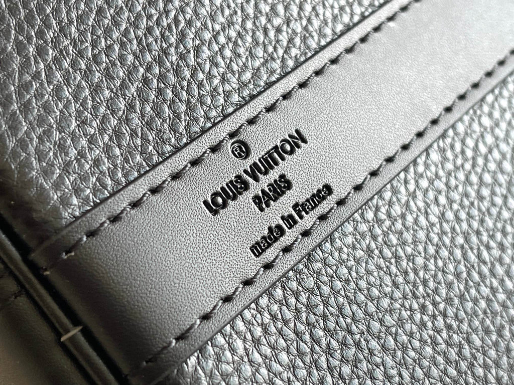 Louis Vuitton made in France label on dark blue textured leather with stitching