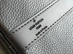 Louis Vuitton made in France label on dark blue textured leather with stitching