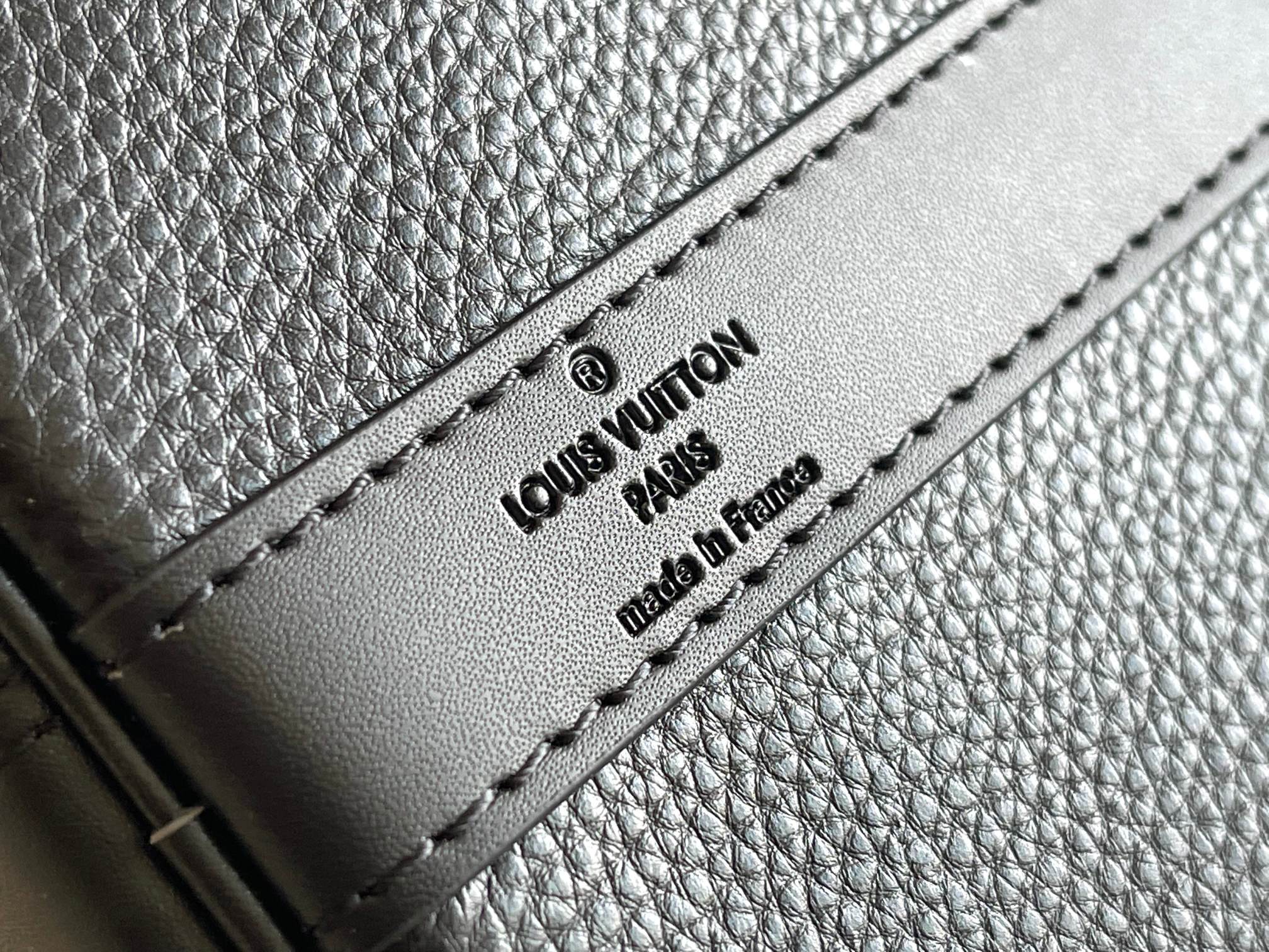 Leather bag interior label with “Louis Vuitton” text and “Paris” on stitched tab