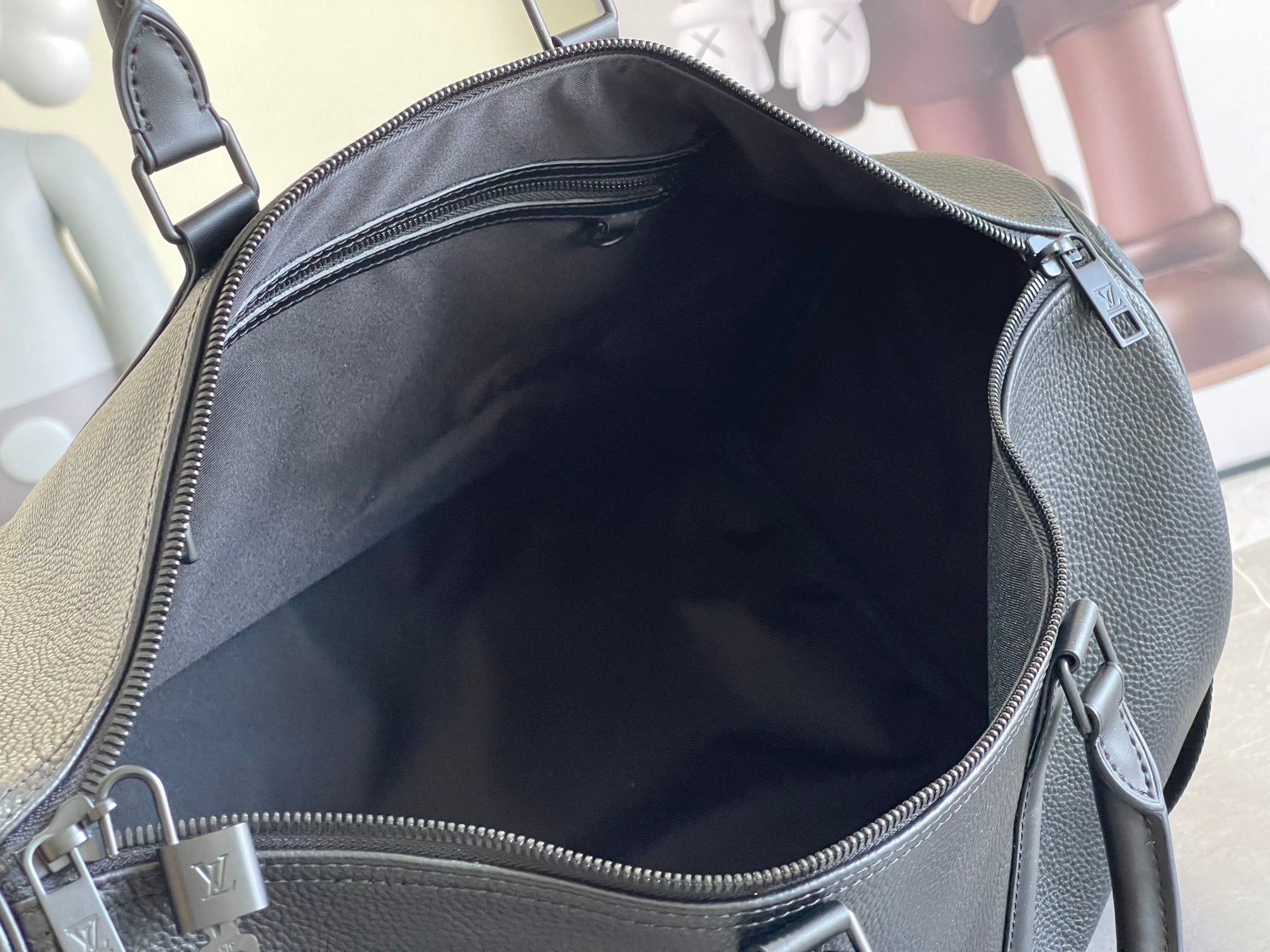 Leather duffle bag interior view with top zipper and hanging zipper pull tab