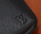 Louis Vuitton black textured leather panel with embossed logo near the edge
