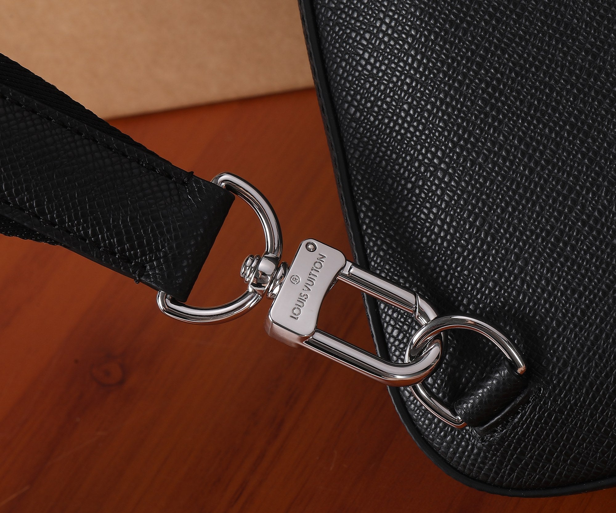 Louis Vuitton black leather bag strap attachment with metal D-ring hardware