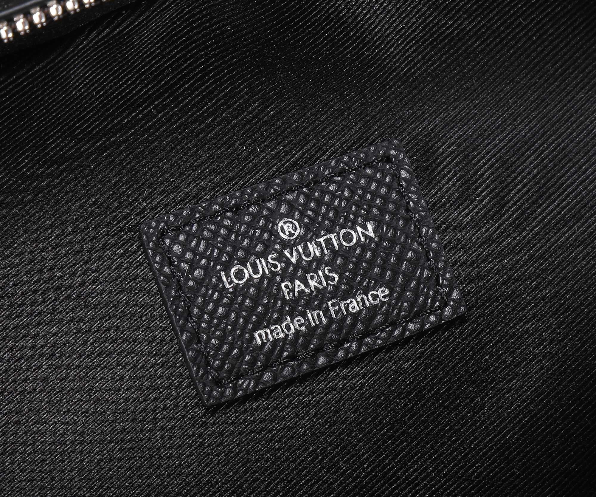 Louis Vuitton Paris "made in France" label patch on black leather panel