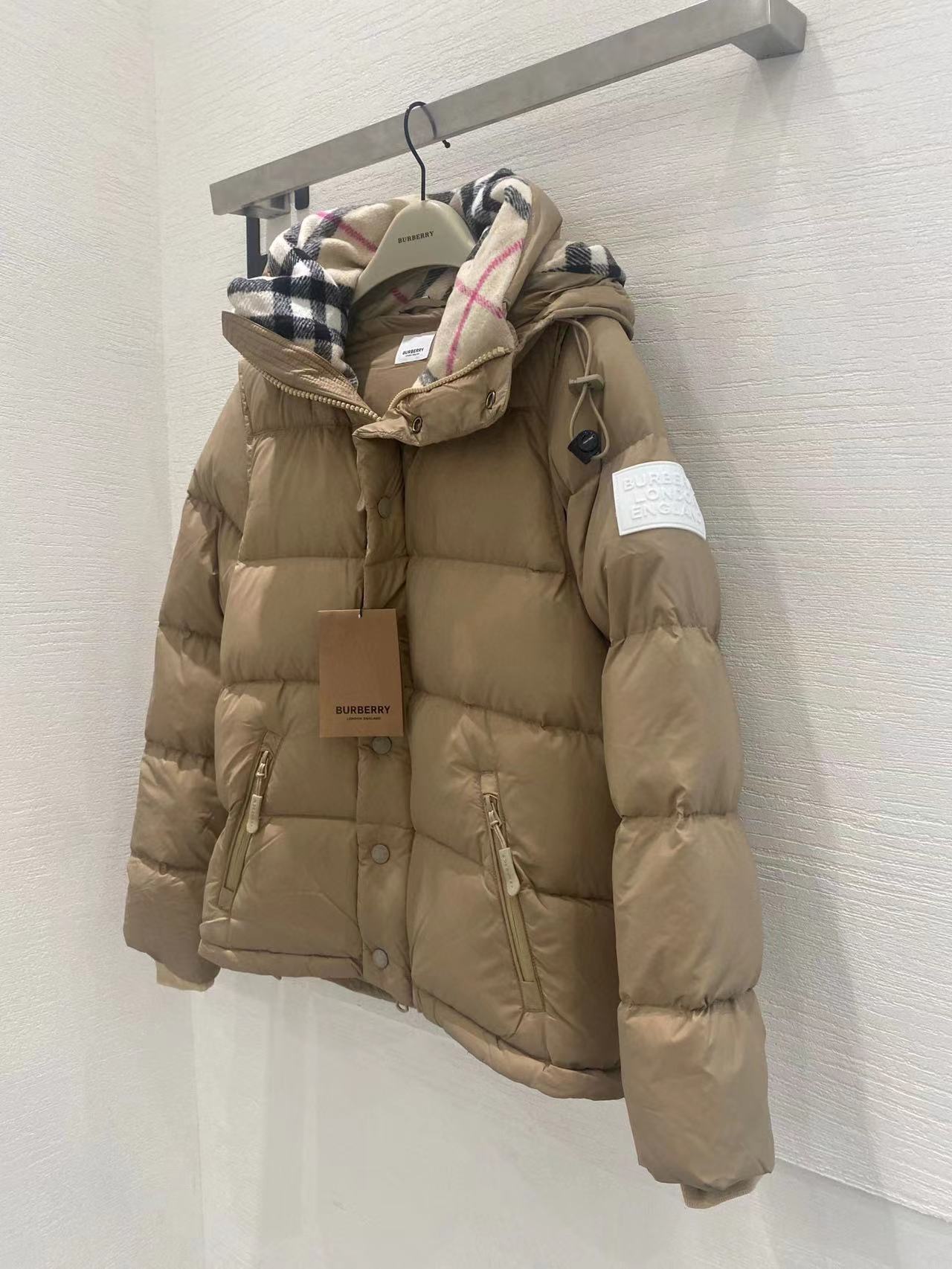Beige hooded puffer jacket with plaid hood lining and side pockets