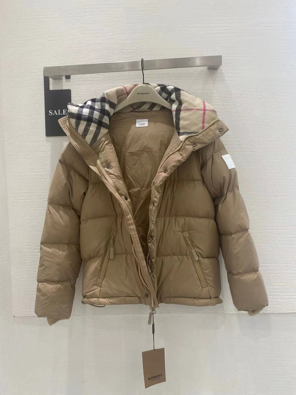 Beige hooded puffer jacket with plaid-trim hood and zip front