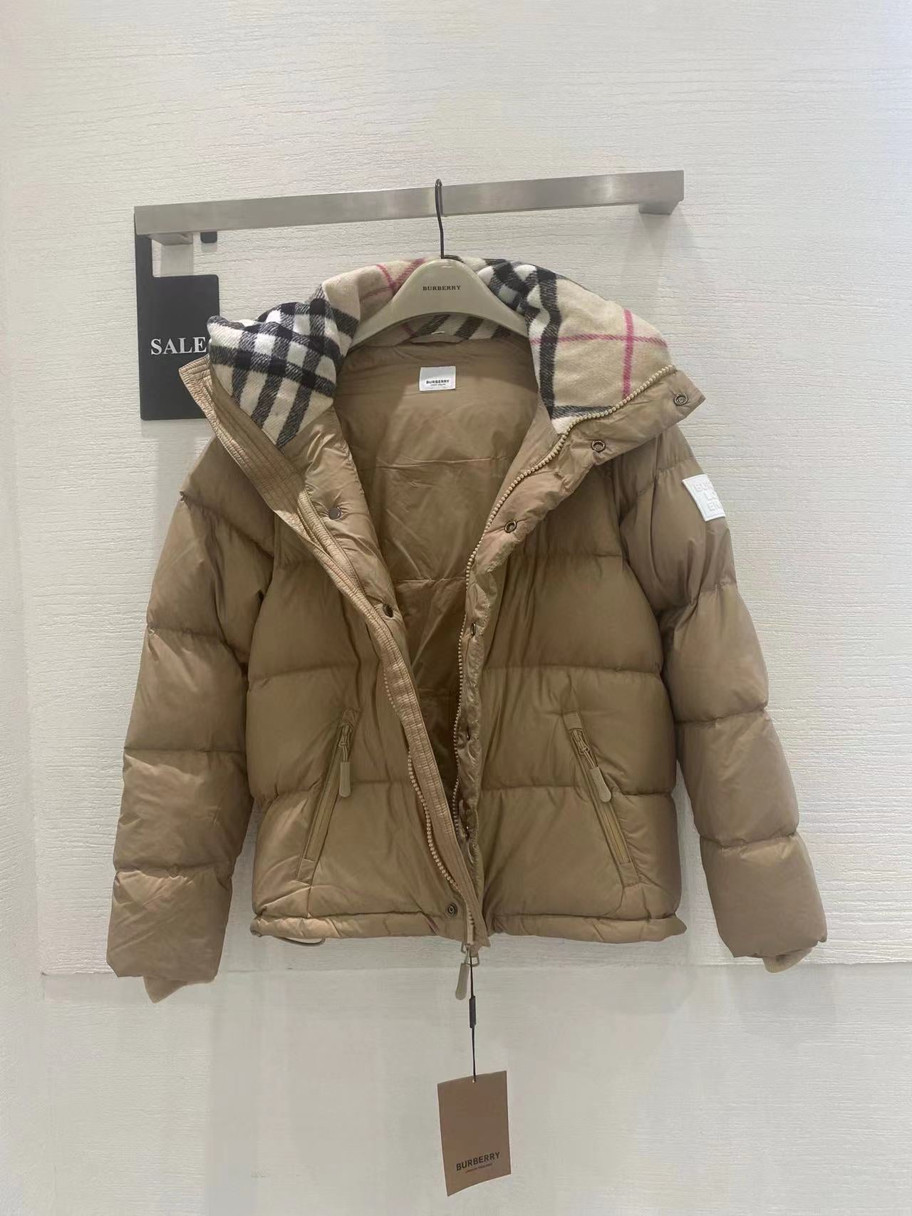 Beige hooded puffer jacket with plaid-trim hood and zip front