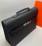Black leather Hermes bag with front buckle clasp and top handle