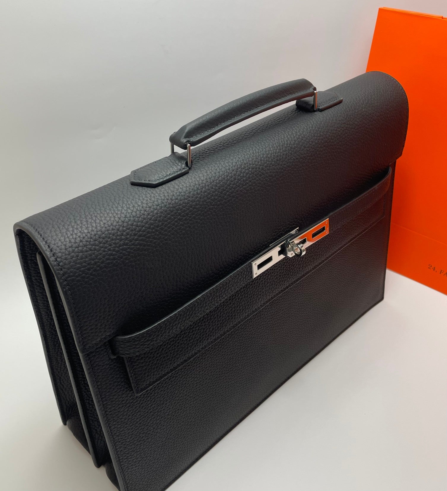 Black leather Hermes bag with front buckle clasp and top handle