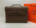 Taupe leather briefcase with top handle and front flap clasp, contrast stitching