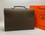 Taupe leather briefcase front view with two side buckle details and top handle