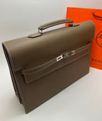 Taupe leather briefcase angled view with front latch and top handle