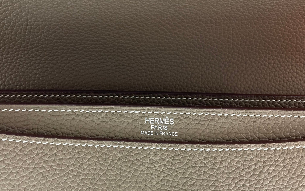 Hermes Paris logo stitched on taupe leather briefcase flap trim