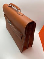 Hermes brown leather briefcase side view with zipper, flap pocket, and metal clasp