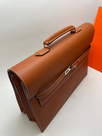 Hermes brown leather briefcase angled view with top handle and front metal lock