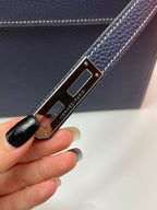 Leather strap with Hermes Paris engraved metal clasp on navy bag