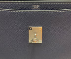 Gold-tone lock plate with Hermes Paris engraving on navy leather bag