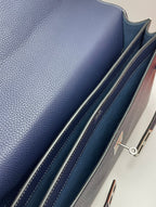 Navy leather bag side panel with stitched trim and zipper hardware