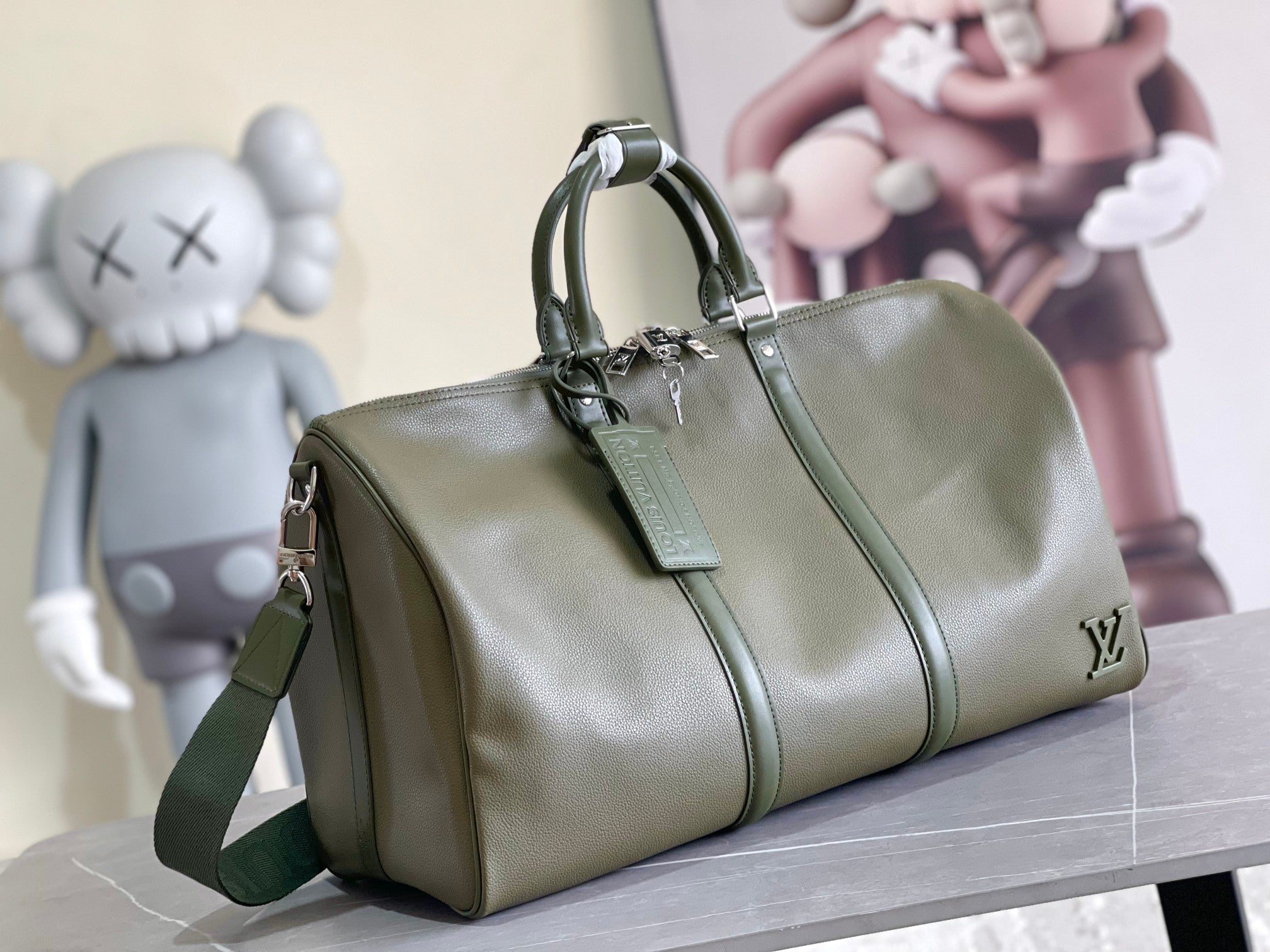 Men's Louis Vuitton duffel bag in olive green leather with top handles and front zip