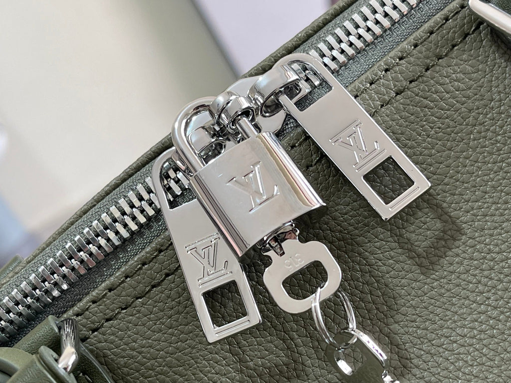 Silver-tone zipper pulls and logo charms on olive green leather lining