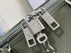 Silver-tone zipper pulls and logo charms on olive green leather lining