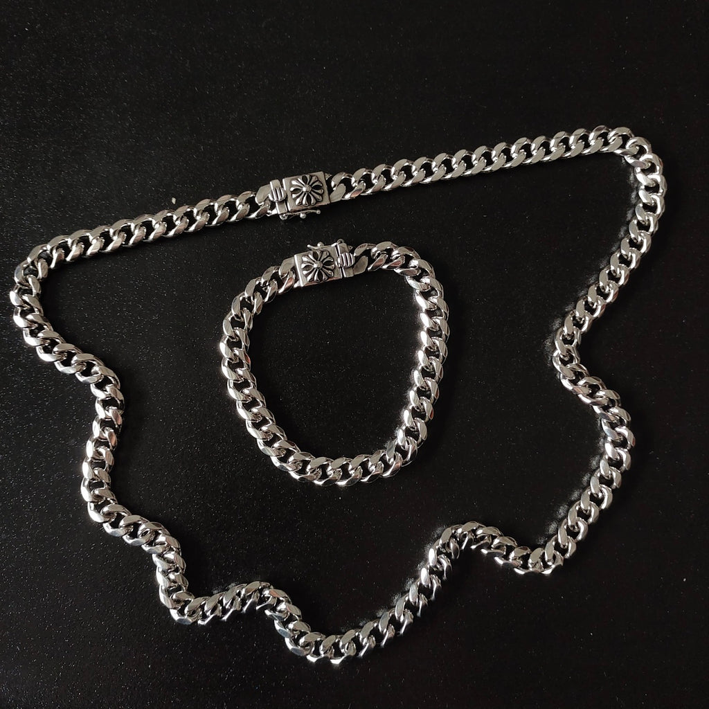 Silver chain necklace with floral bead accents, chunky link design
