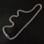 Silver chain necklace with chunky links and small floral charm detail