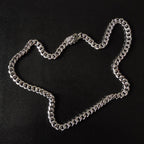 Silver chain necklace with chunky links and floral charm centerpiece