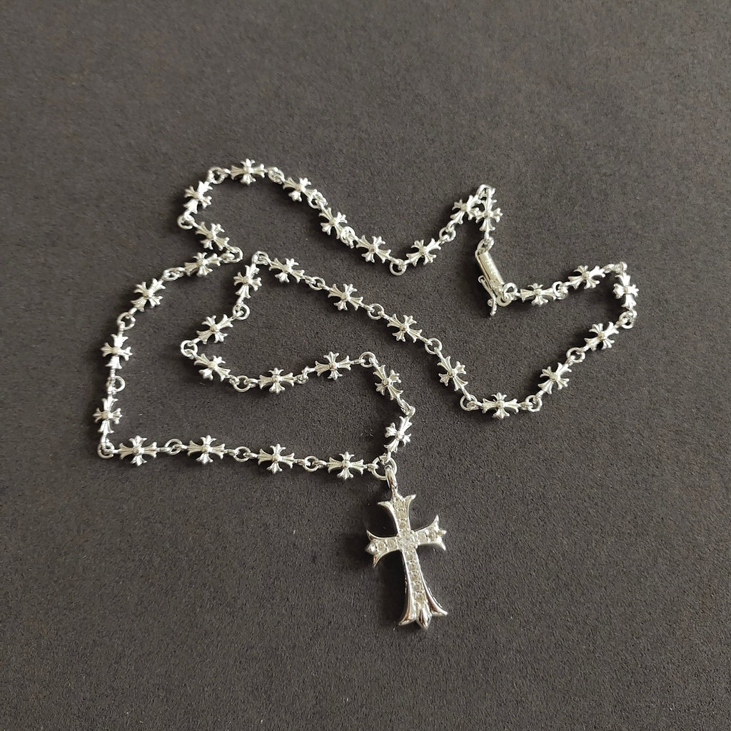 Silver cross pendant necklace with floral link chain