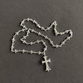 Silver cross pendant necklace with floral link chain