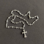 Silver cross pendant necklace with floral link chain