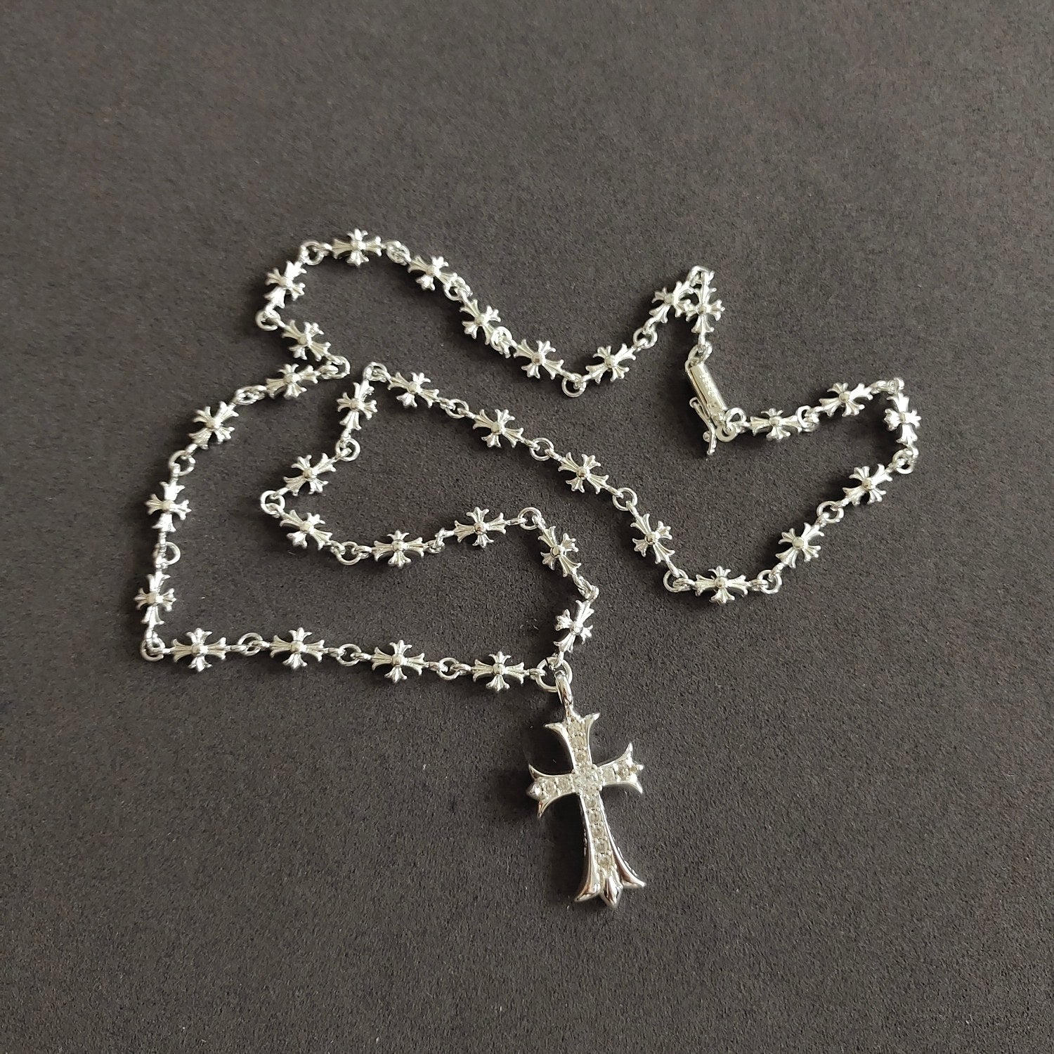 Silver cross pendant necklace with floral link chain