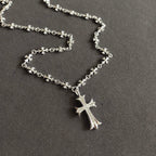 Silver cross pendant necklace, close view of chain and cross charm