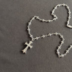 Silver cross pendant necklace with dangling cross charm and floral chain