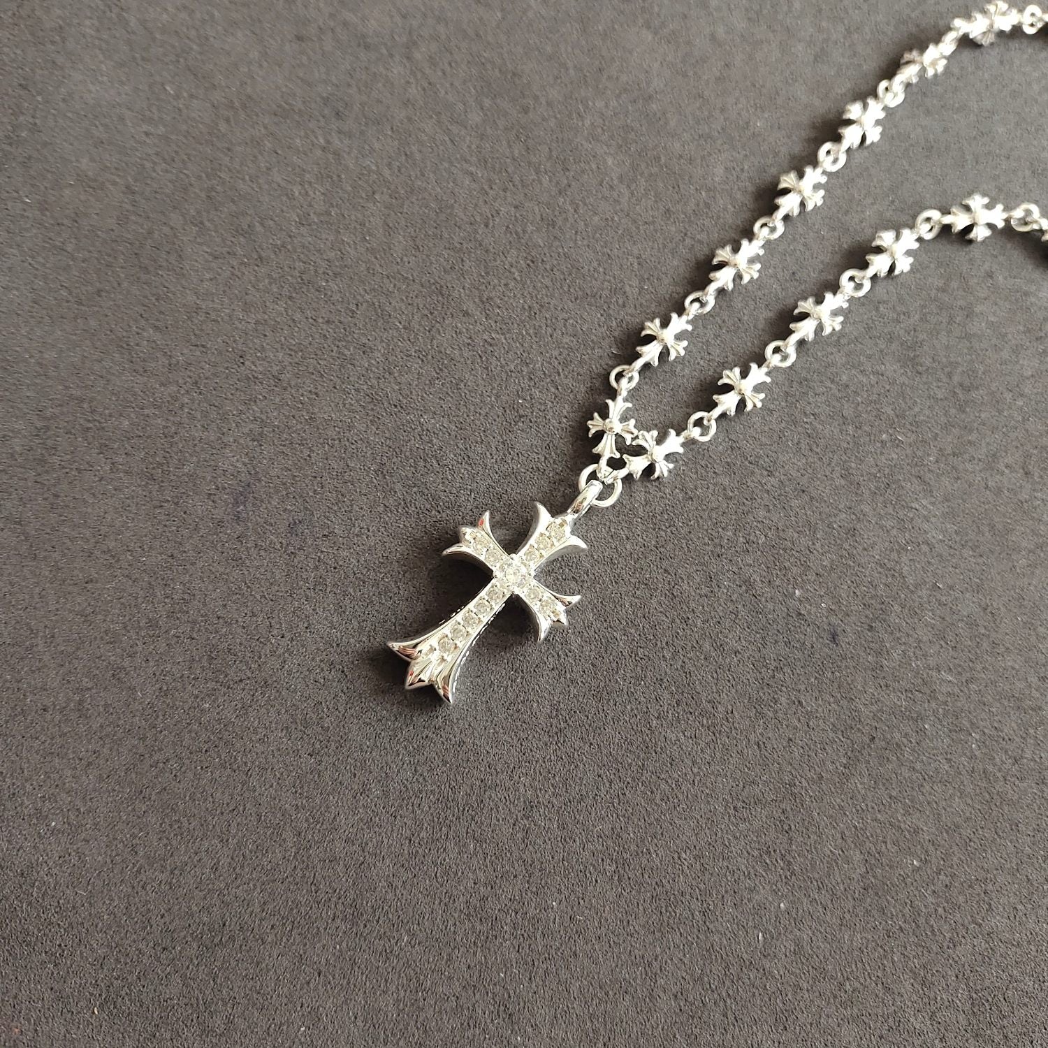 Silver cross pendant necklace with cross charm on floral chain links