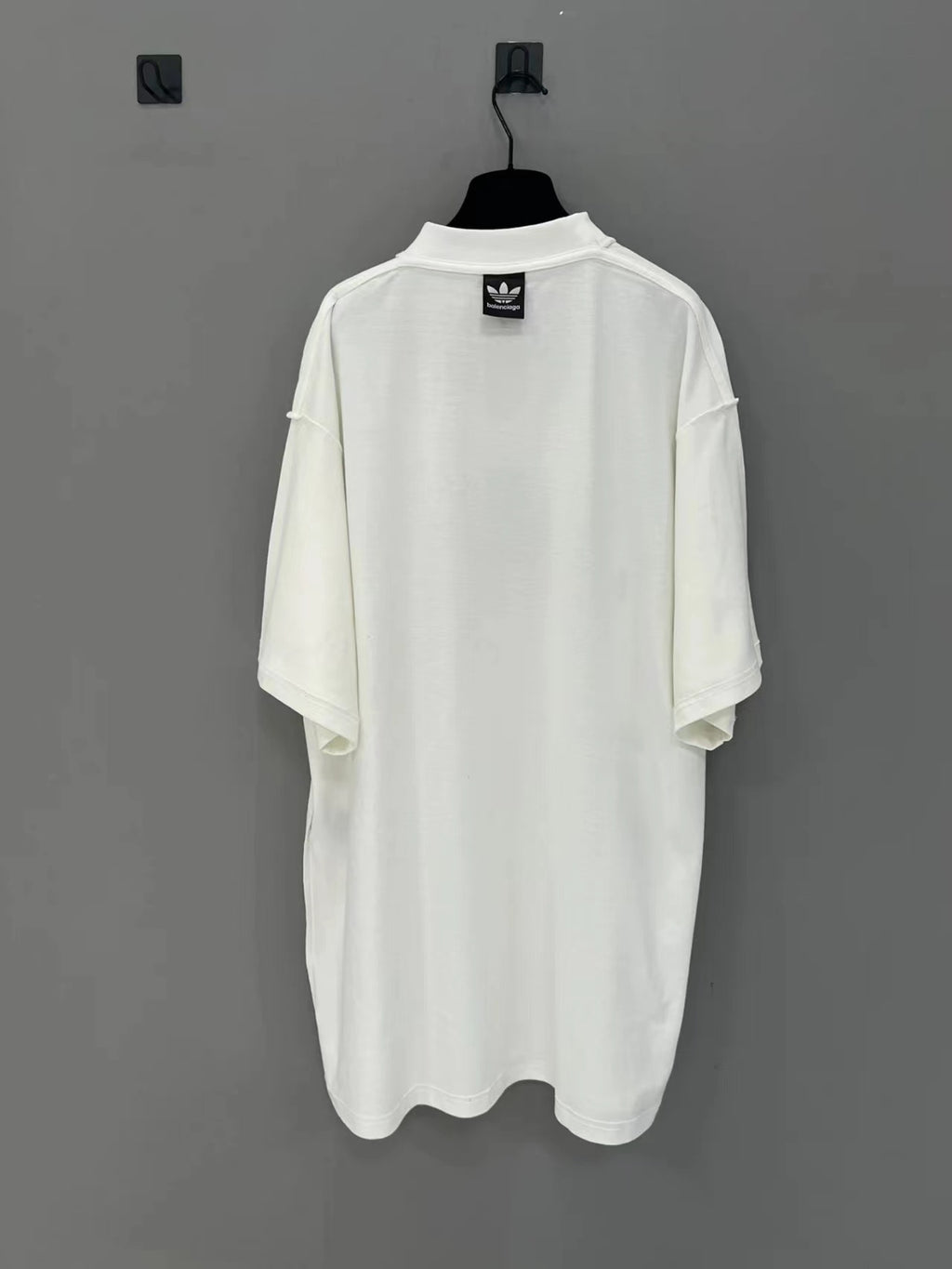 White short-sleeve T-shirt back view with Balenciaga logo patch at collar