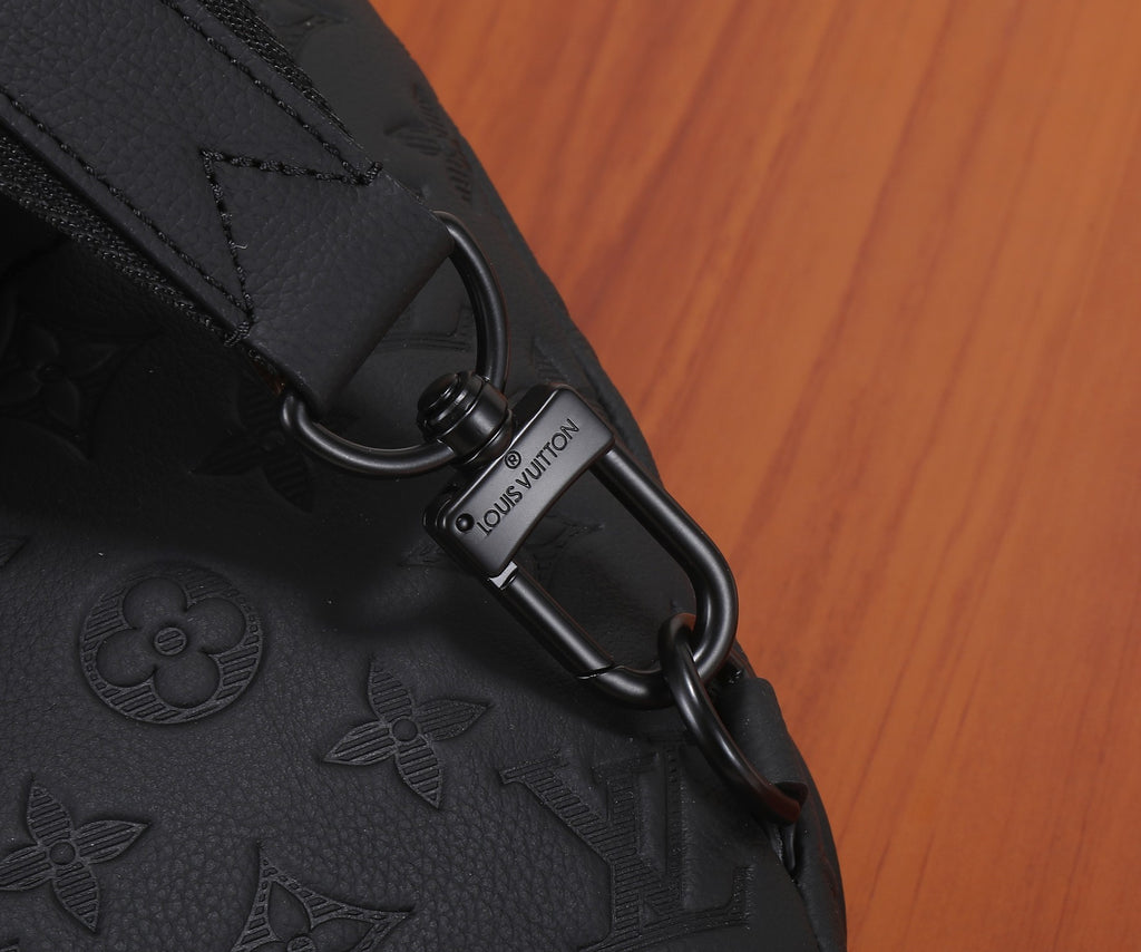 Louis Vuitton bag metal key ring detail engraved on black strap